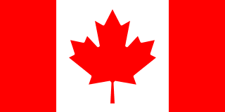 The flag of Canada is composed of a red vertical band on the hoist and fly sides and a central white square that is twice the width of the vertical bands. A large eleven-pointed red maple leaf is centered in the white square.